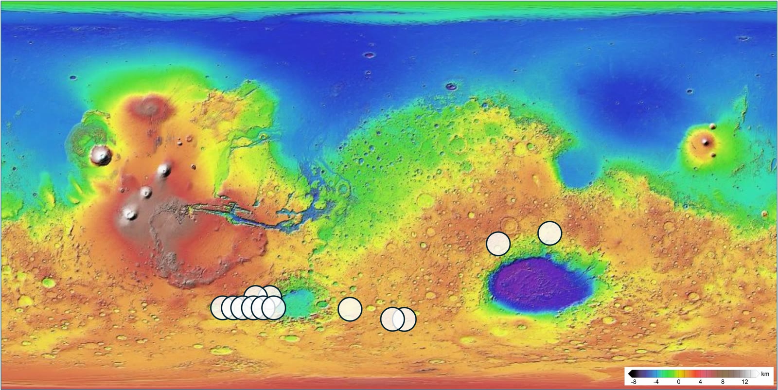 Colour elevation map of Mars from low blue basins to high red volcanic regions, with white circles marking areas in the southern hemisphere.